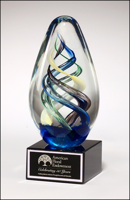 Egg-shaped art glass award on black glass base