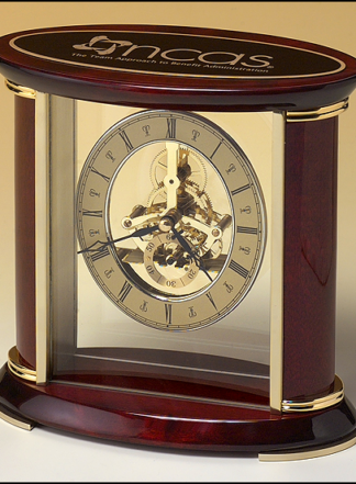 Skeleton clock with sub-second dial, brass finished movement and rosewood piano finish accents.
