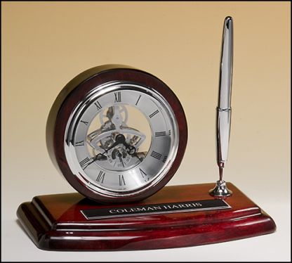 Skeleton clock, silver movement and pen with rosewood piano-finish case.