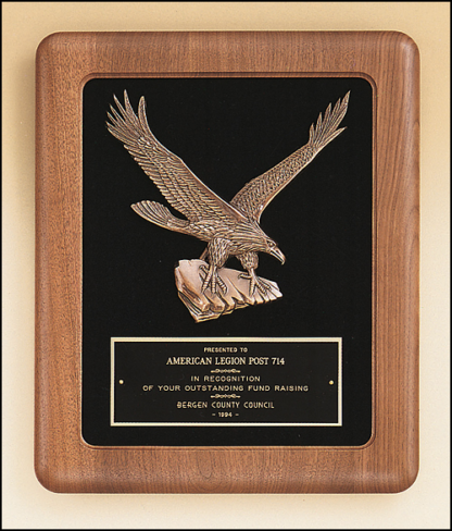 Eagle Plaques American walnut Airflyte frame with a sculptured relief eagle casting on a black velour background.